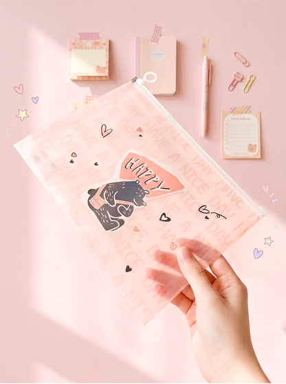 Clear plastic pouch with cartoon designs held by a hand on a light blue background