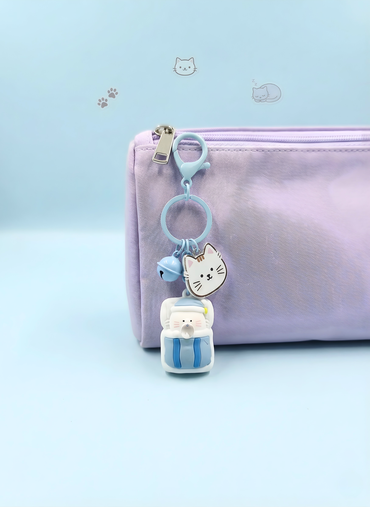 Keychain with a cat design attached to a pink pouch on a light blue background