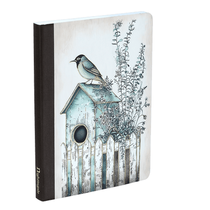 Notebook with a birdhouse and bird illustration on the cover