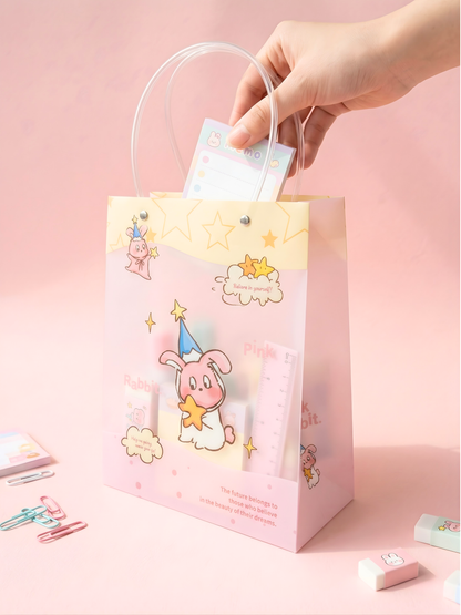 Hand holding a pink gift bag with cartoon character on a pink background