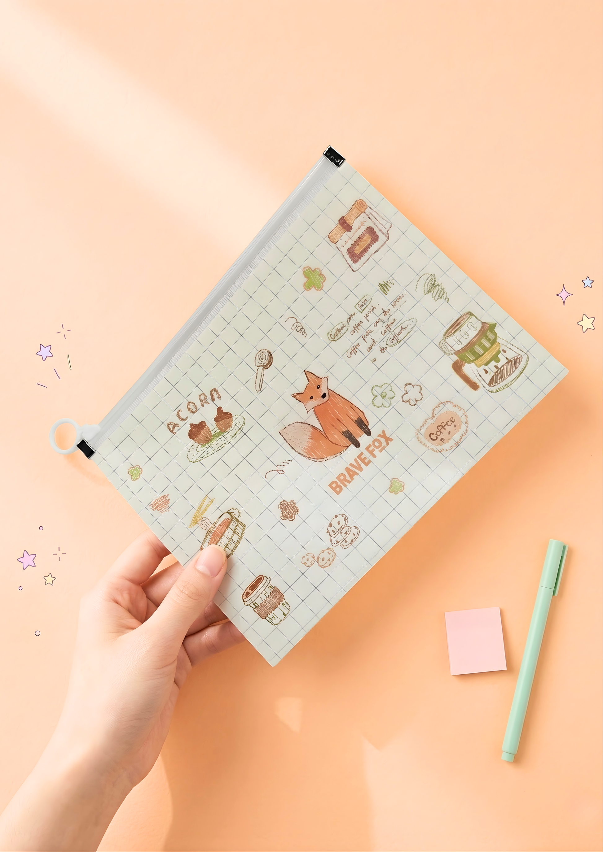 Planner with cute illustrations held by a hand on a peach background