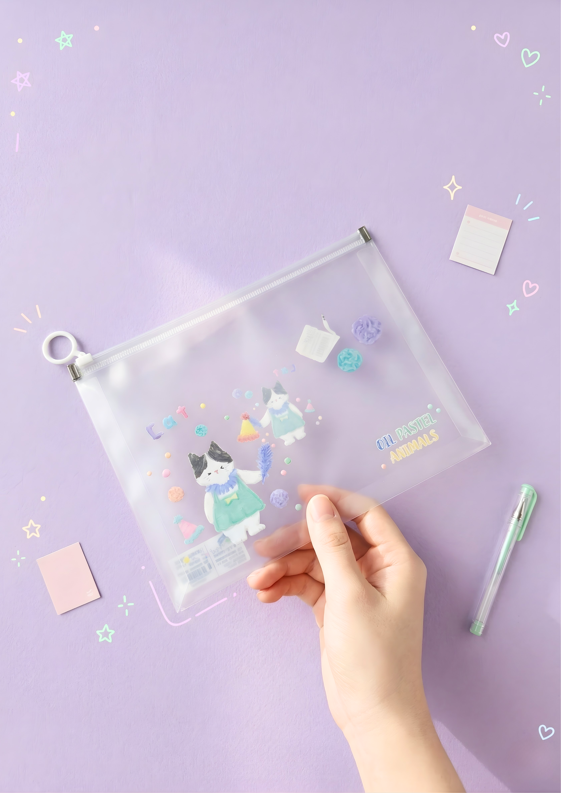 Clear pouch with cartoon cat design held by a hand on a purple background