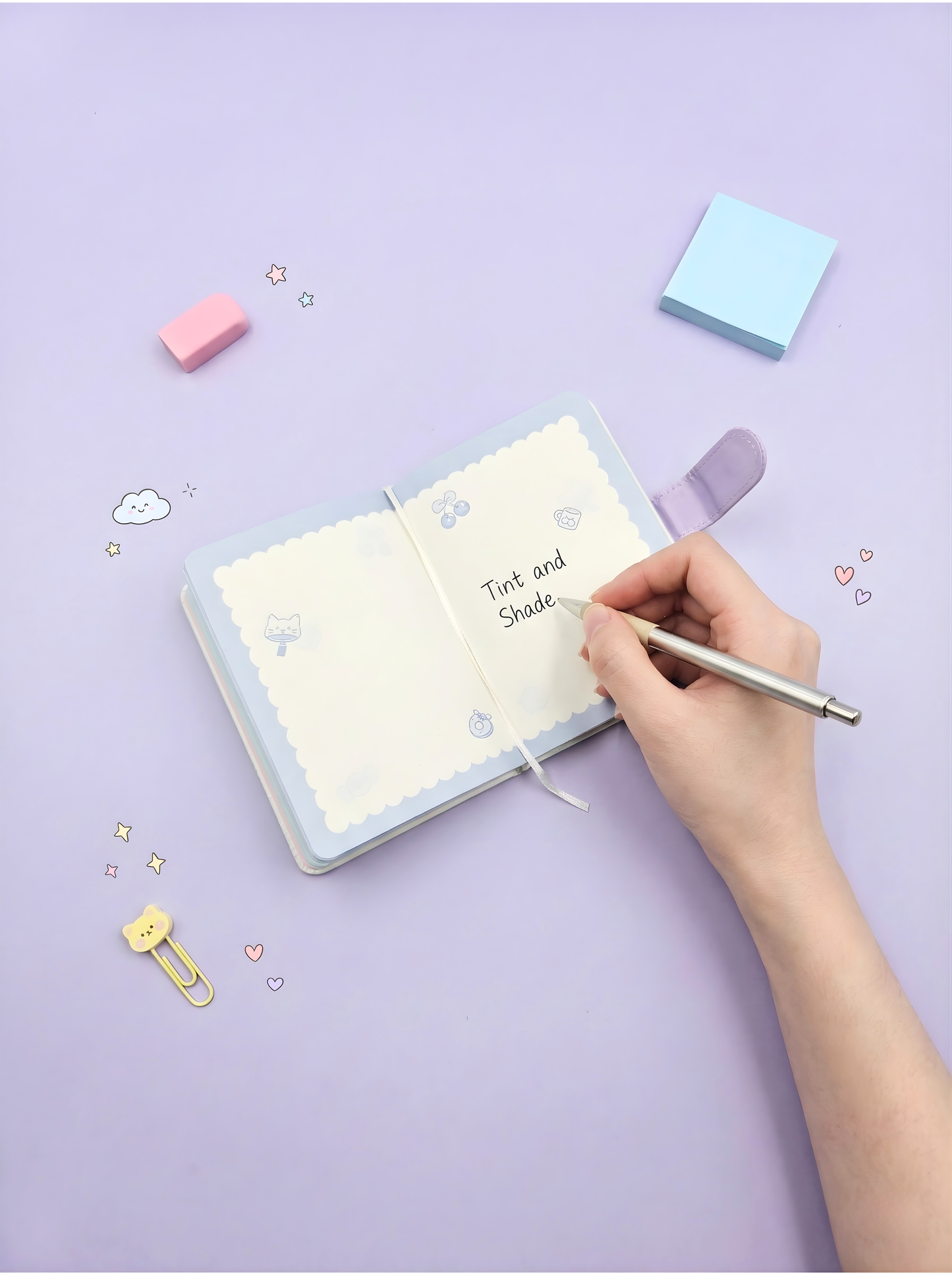 Hand holding a pen over a notebook with 'Tint and Shade' written on it, on a light purple background.