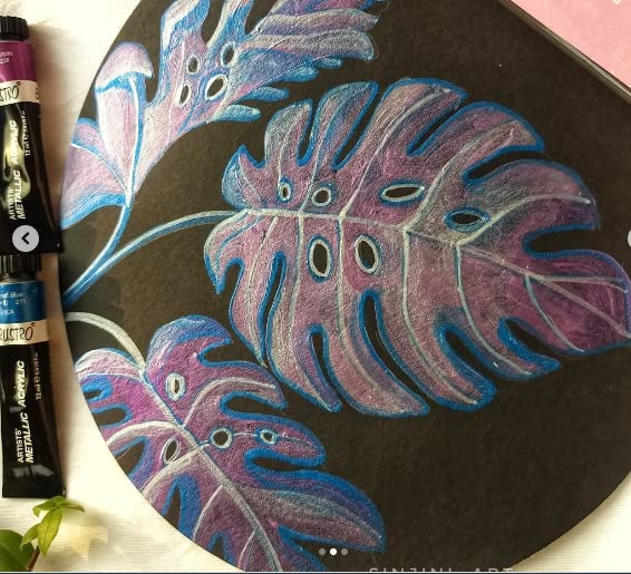 Colorful leaf illustration on a blackboard with markers next to it