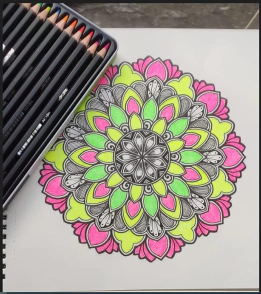 Coloring book with a mandala design and colored pencils on a table.