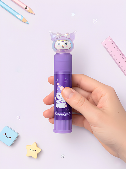 Hand holding a purple cartoon character pen with stationery items on a light purple background