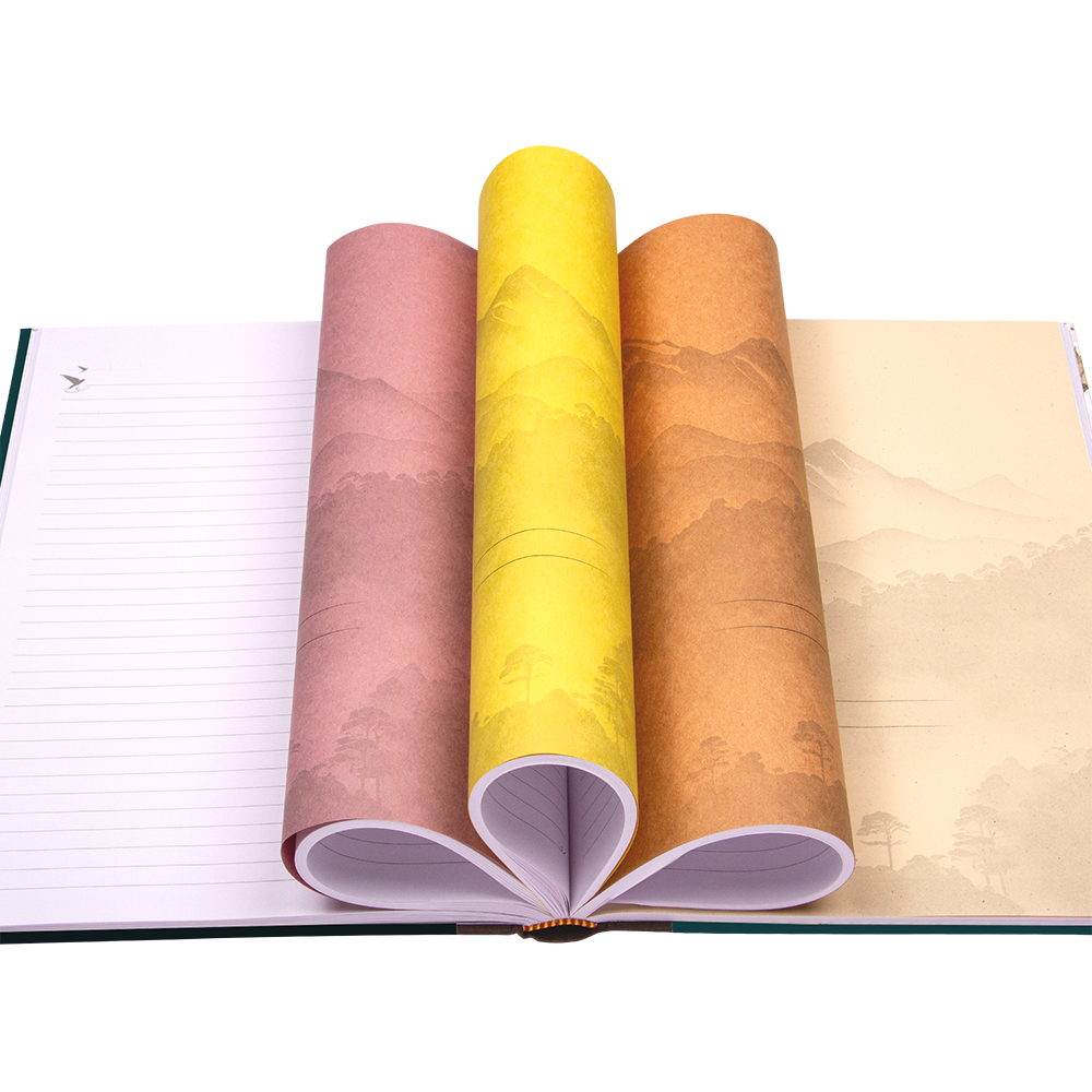 Rolls of colorful paper over an open notebook on a white background