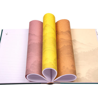 Rolls of colorful paper over an open notebook on a white background