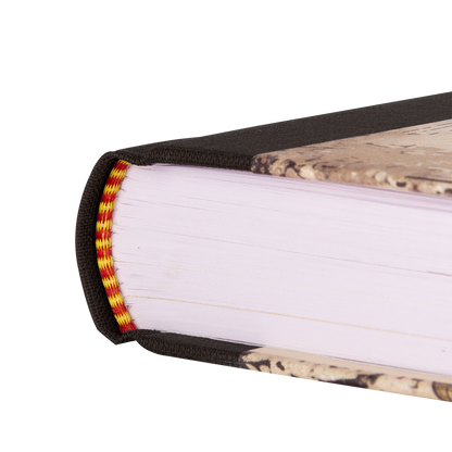 Close-up of a book with a decorative tape binding on a white background