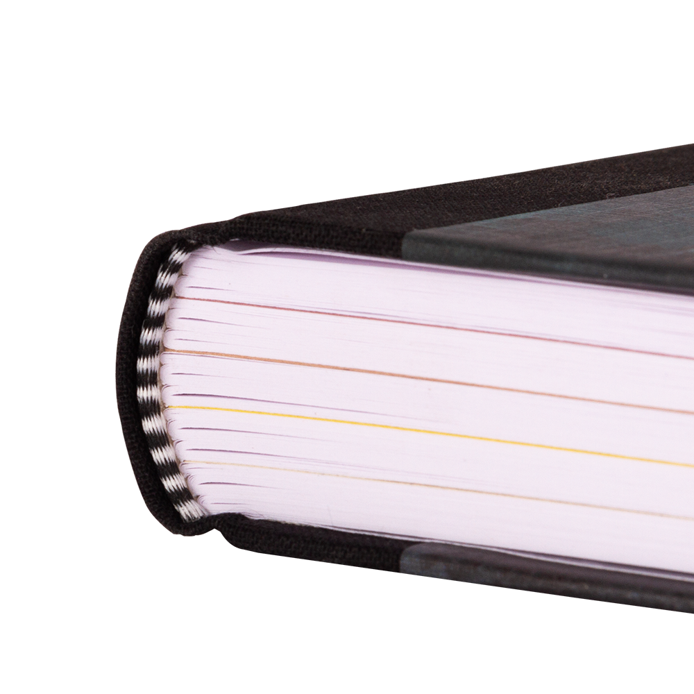 Close-up of a book with black binding and white pages on a white background