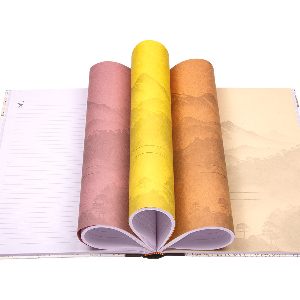 Four rolls of colorful paper with landscape design on a notebook