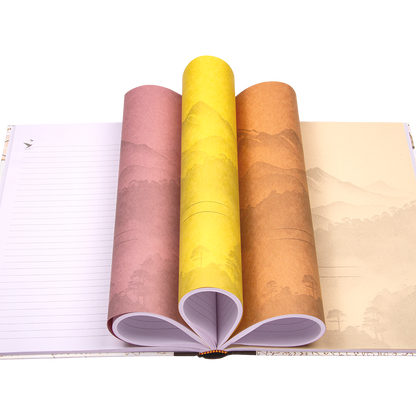 Four rolls of colorful paper with landscape design on a notebook