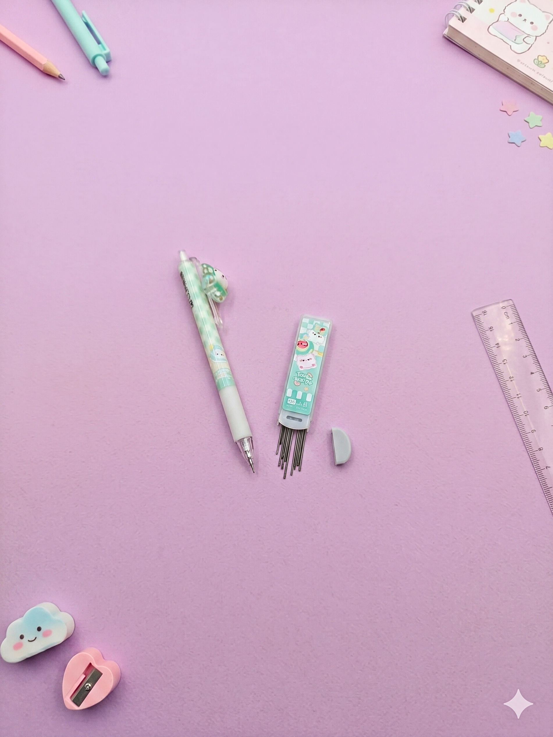 Stationery items including a pen, ink refills, and a ruler on a purple background