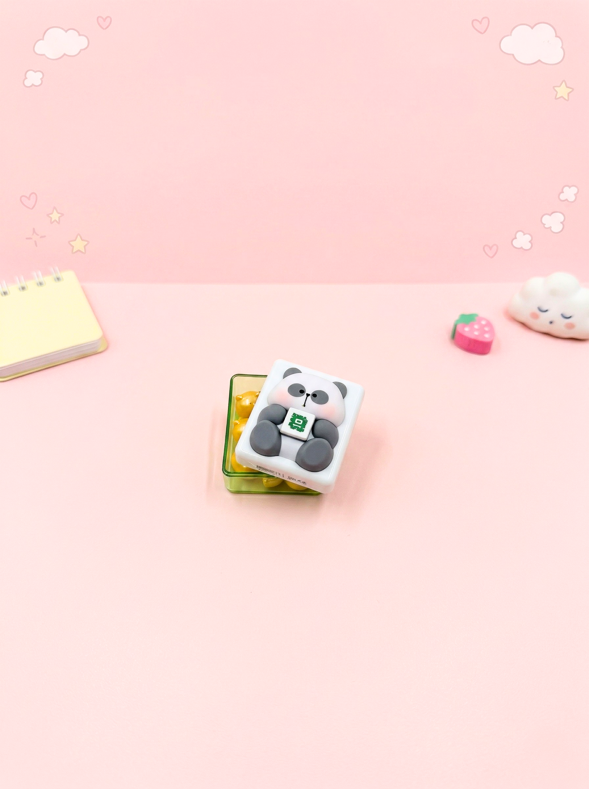 Cute panda-shaped eraser on a pink background with decorative elements