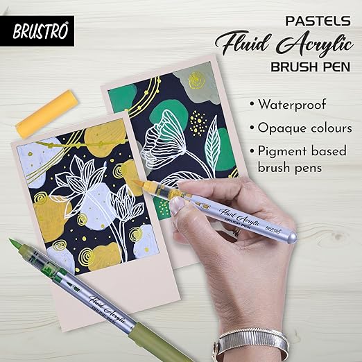 Hand holding a fluid acrylic brush pen over a card with floral design, with BRUSTRO branding.