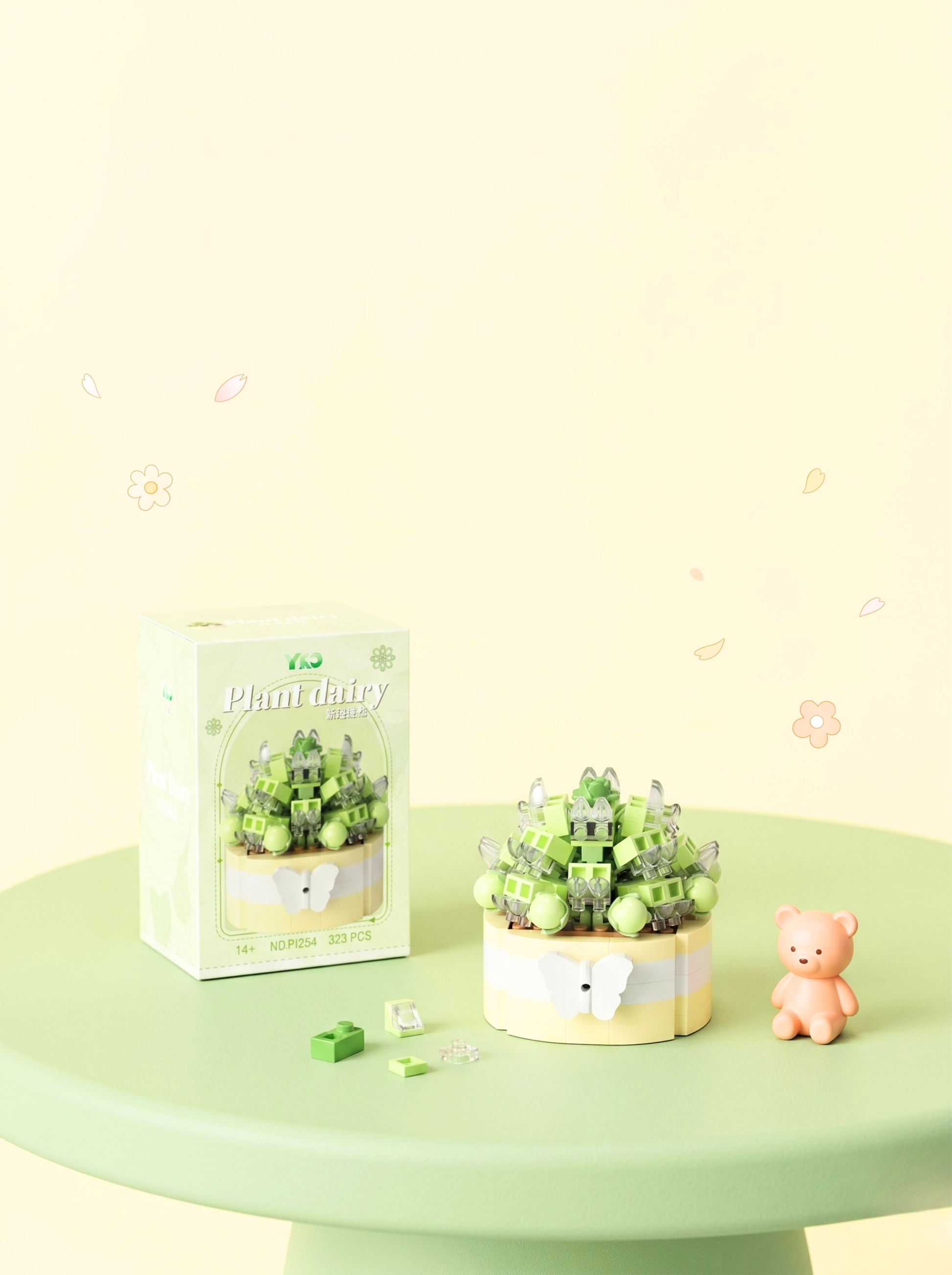 Miniature garden with a teddy bear on a green surface, featuring a 'Plantable' product packaging.