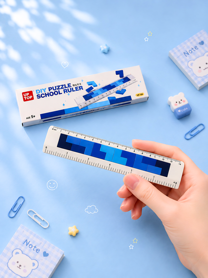 Hand holding a ruler with a blue gradient design on a light blue background with stationery items.