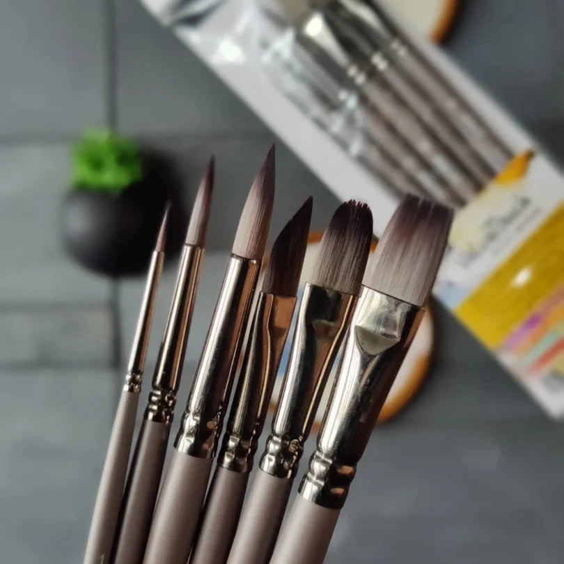 Set of paintbrushes on a gray surface with a blurred background