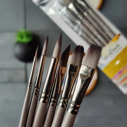 Set of paintbrushes on a gray surface with a blurred background
