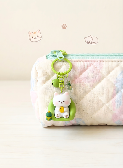 Pouch with a cat-shaped keychain on a light background