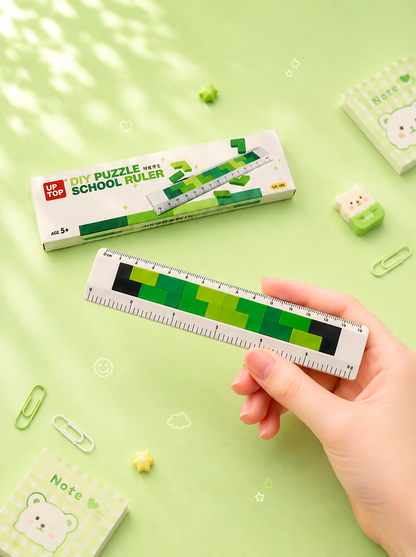 Hand holding a ruler with a green and black design on a light green background