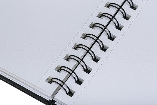 Close-up of a spiral-bound notebook with white pages.