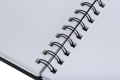 Close-up of a spiral-bound notebook with white pages.