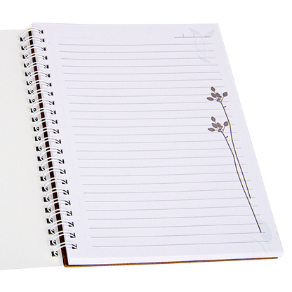 Open notebook with lined pages and a floral drawing on a white background