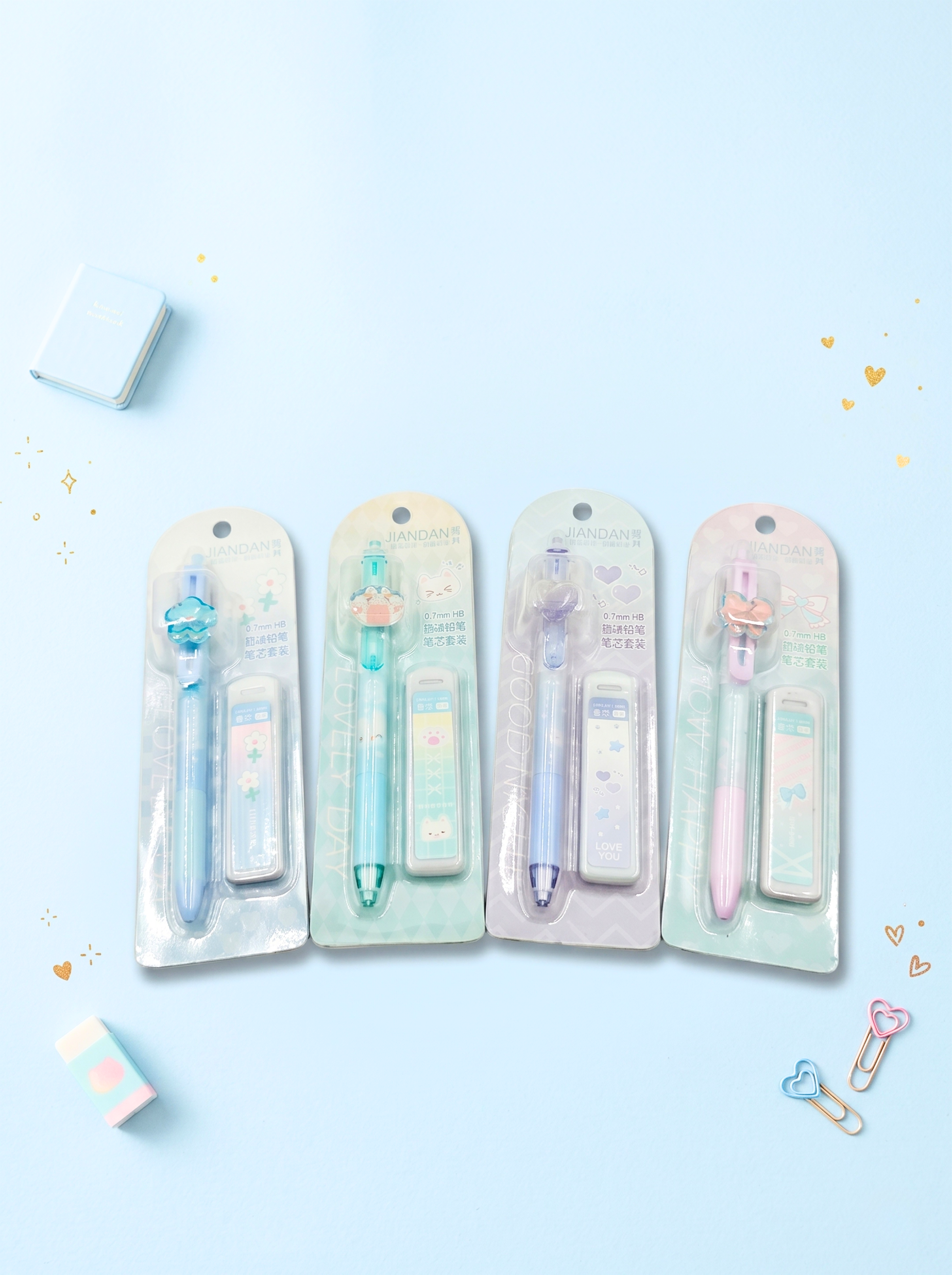 Four packages of colorful pens on a light blue background
