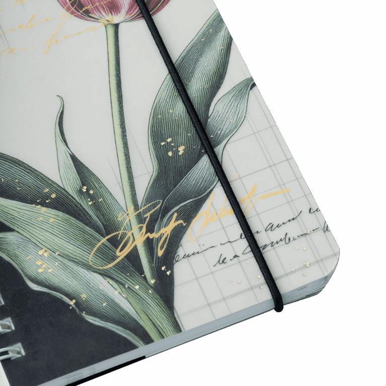 Notebook with floral design and black strap on a light gray background
