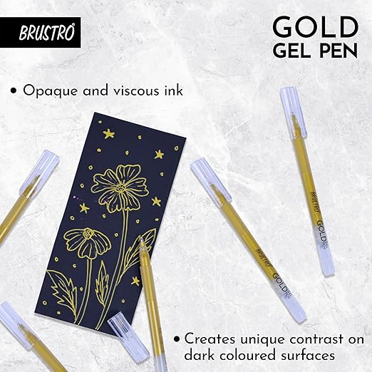 Gold gel pen with decorative notebook on a textured white background