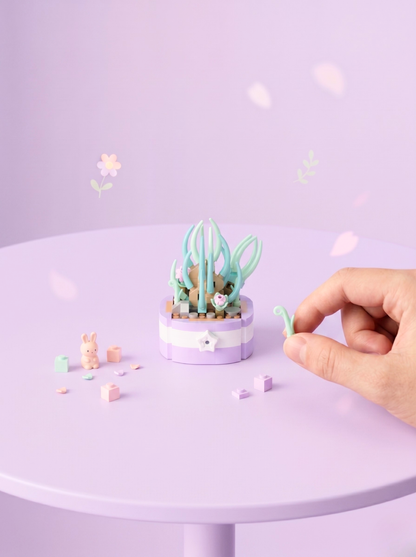 Small decorative garden with a hand interacting on a light purple background
