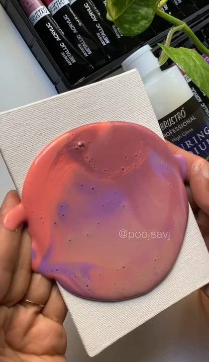 Pink and purple gradient soap held by a hand on a white background with visible branding.
