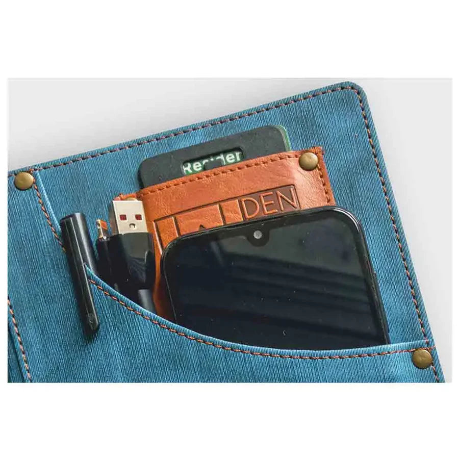 Smartphone in a denim pocket with a leather cardholder labeled 'DEN'.