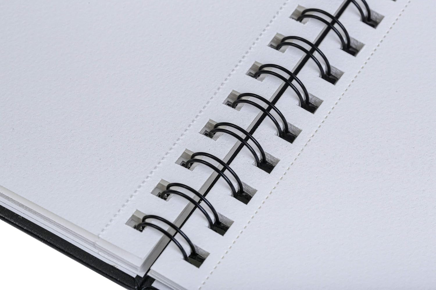 Close-up of a notebook with a spiral binding on a white background