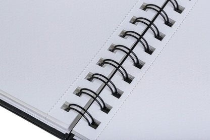 Close-up of a notebook with a spiral binding on a white background