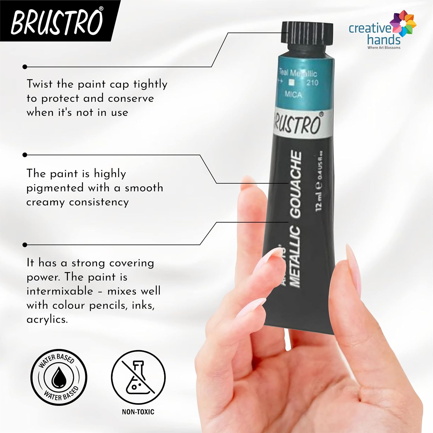 Brustro metallic gouache paint tube with features and hand holding it on a white background