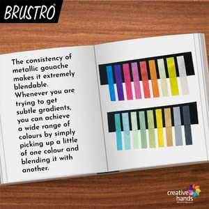 Open book with color swatches and text on a wooden surface, featuring the brand 'Brustro'.