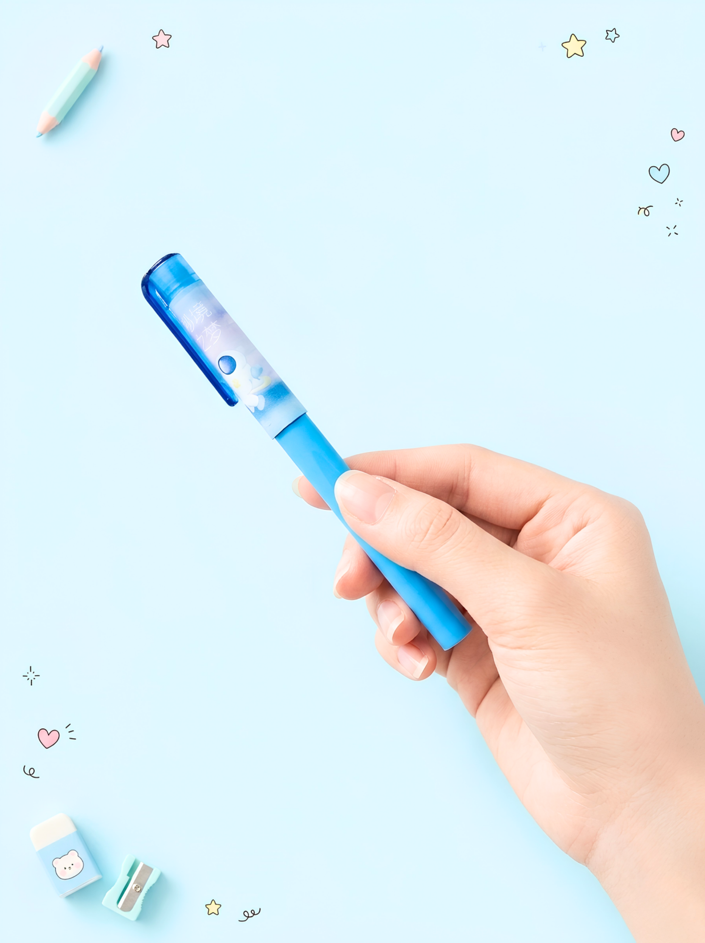 Hand holding a blue pen against a light blue background with decorative elements.