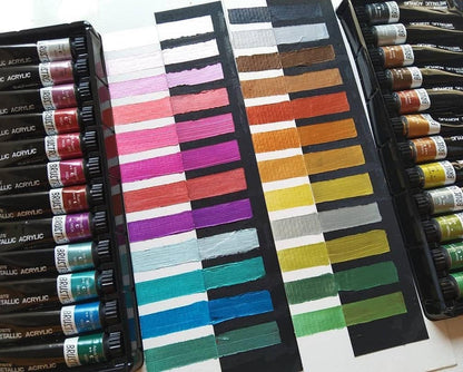 Set of acrylic paint tubes with color swatches on a white background
