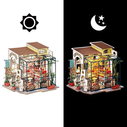Model of a miniature house with interior details on a white background, showing a day and night view.