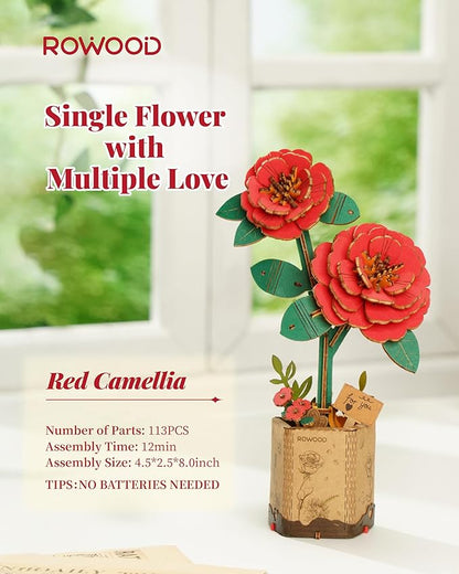 Wooden red camellia flower set with packaging on a light background