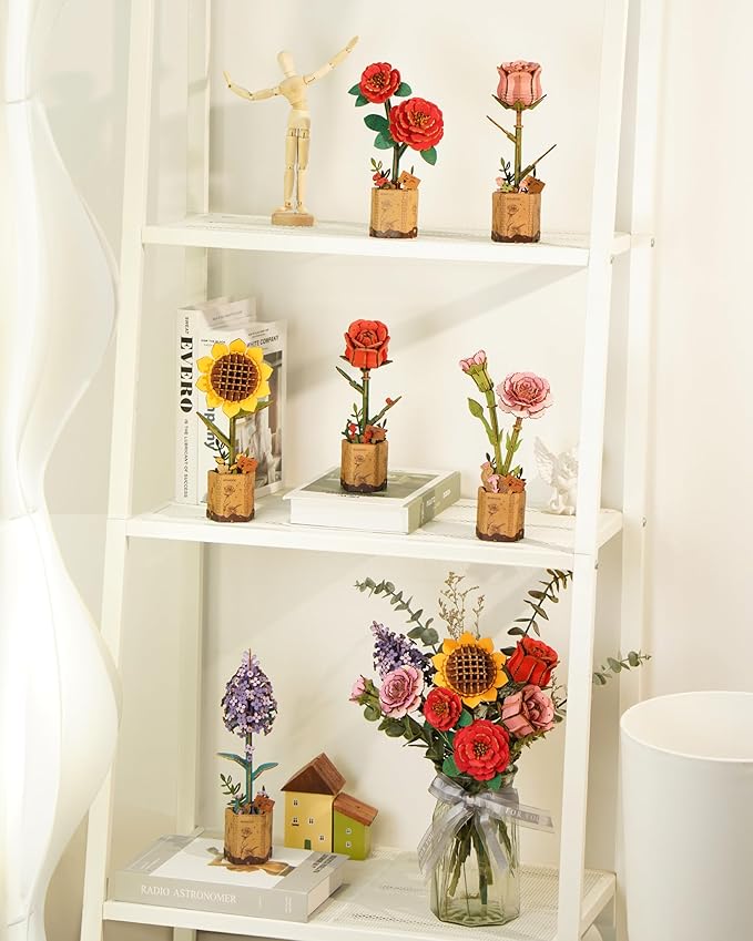 Decorative shelves with small potted plants and flowers on a white background