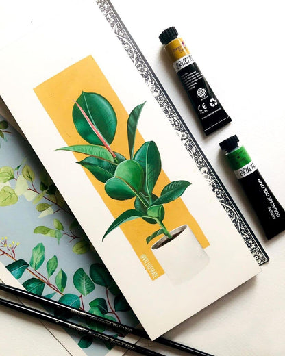 Notebook with plant illustration, paint tubes, and brushes on a white background