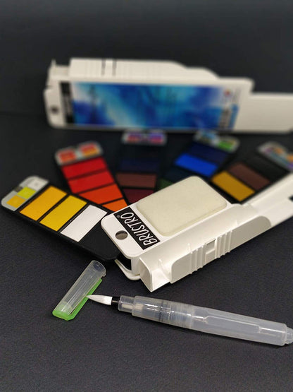 Brustro watercolor pan set with a brush on a dark surface