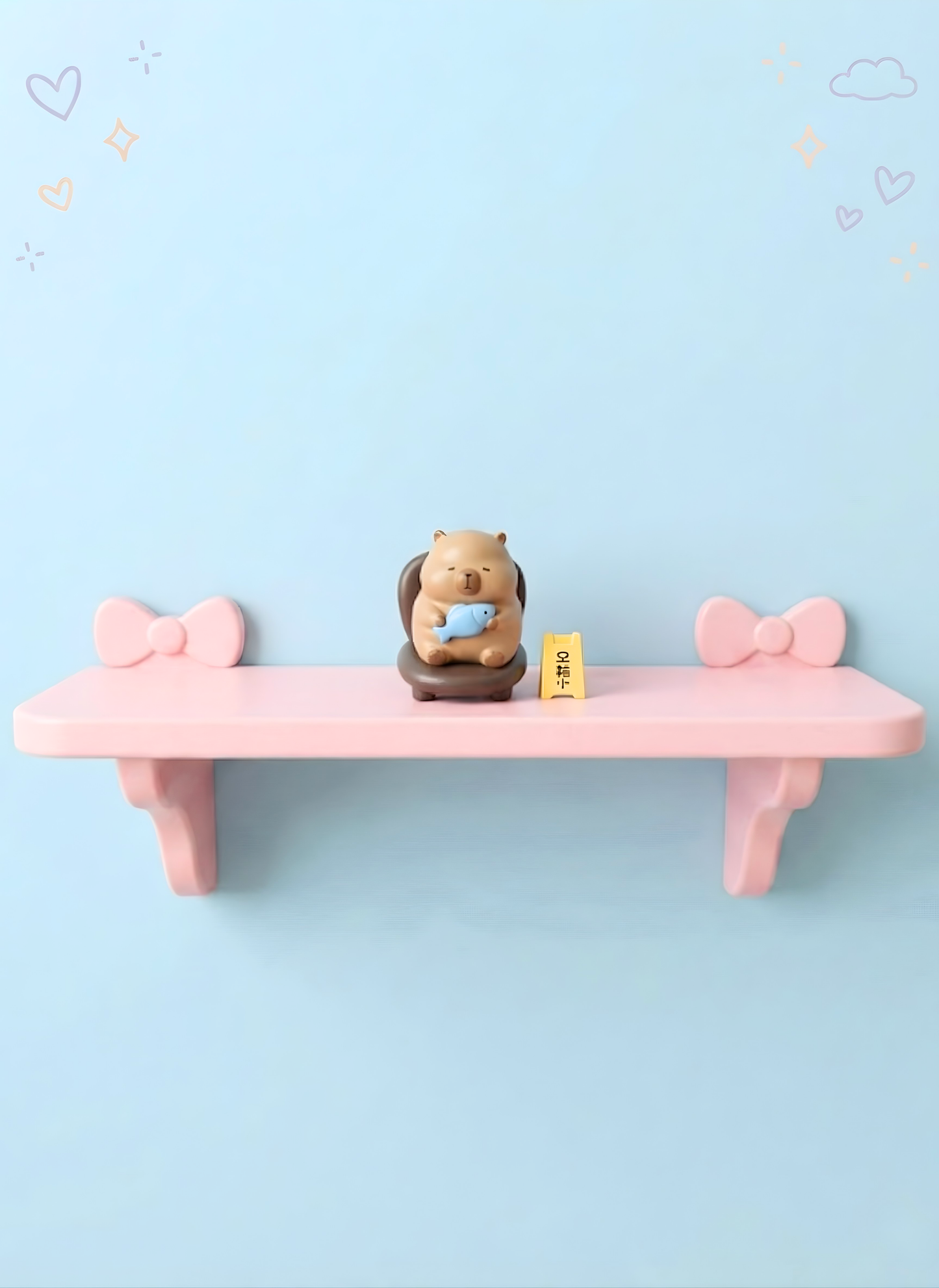 Pink shelf with decorative bows on a light blue background