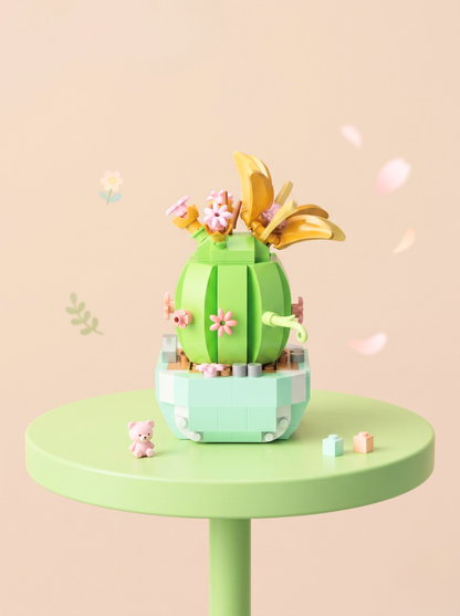 Colorful cactus-shaped toy on a small round table with a light pink background