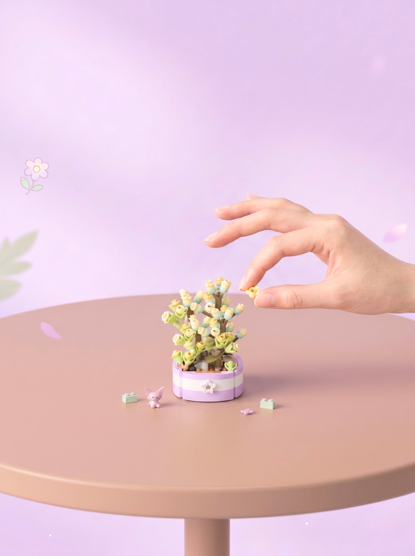 Hand interacting with a small plant on a round table against a light purple background
