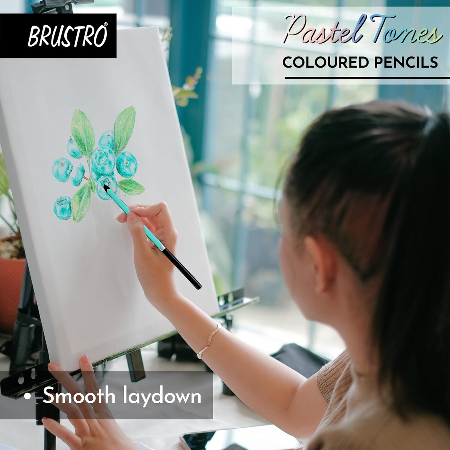 Person using pastel tones colored pencils to draw on an easel with BRUSTRO branding.