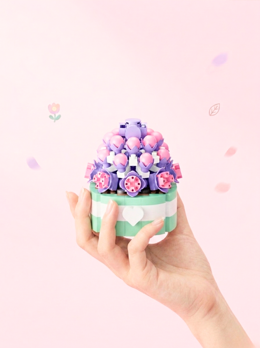 Hand holding a small decorative item with flowers on a pink background